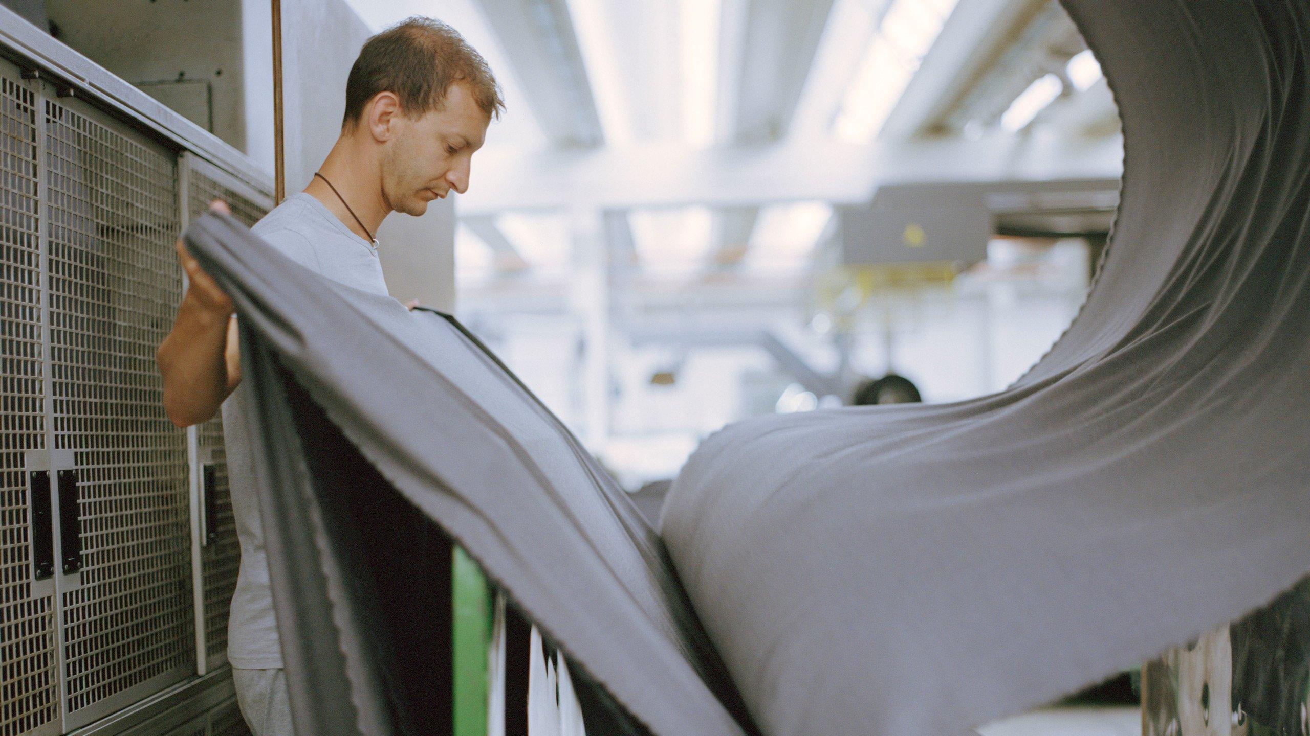 Man at fabric mill making custom suit fabric