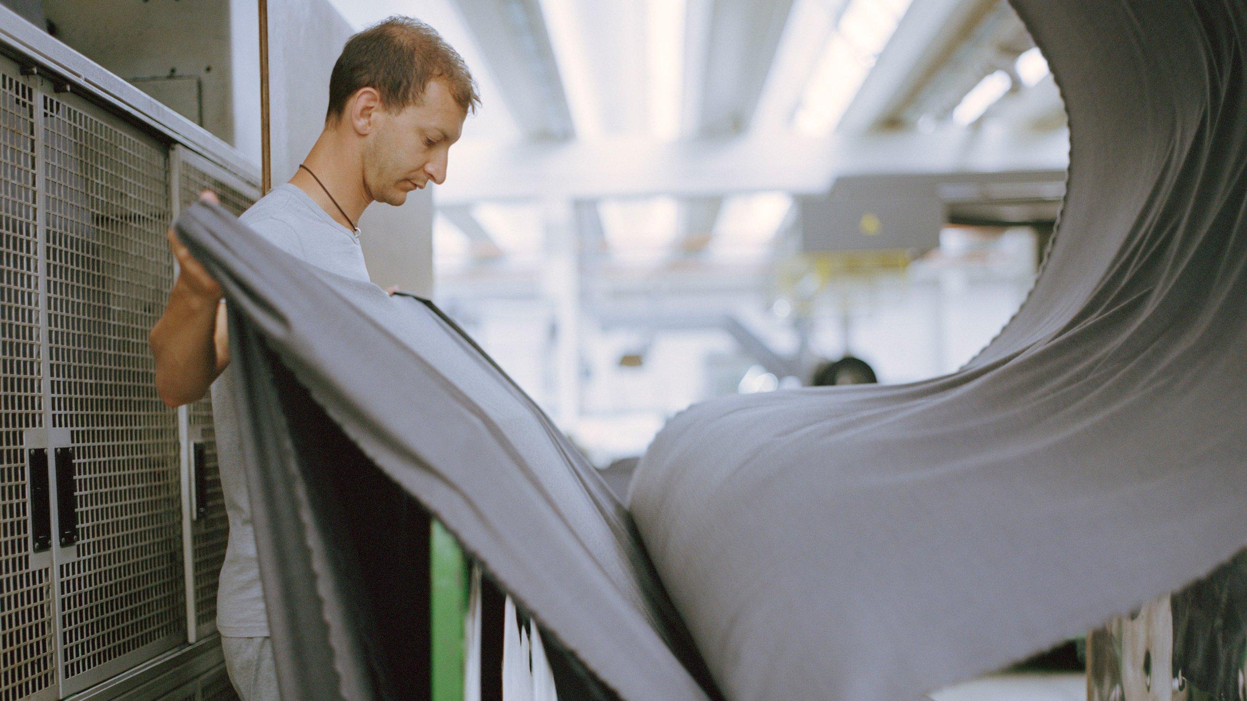 Man at fabric mill making custom suit fabric